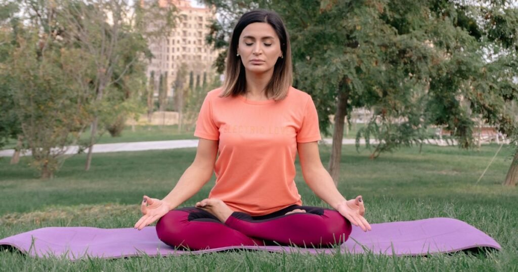 This image shows that the woman sitting on grass and breathe